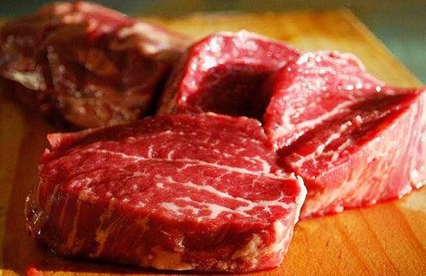 beef pieces on a wooden table